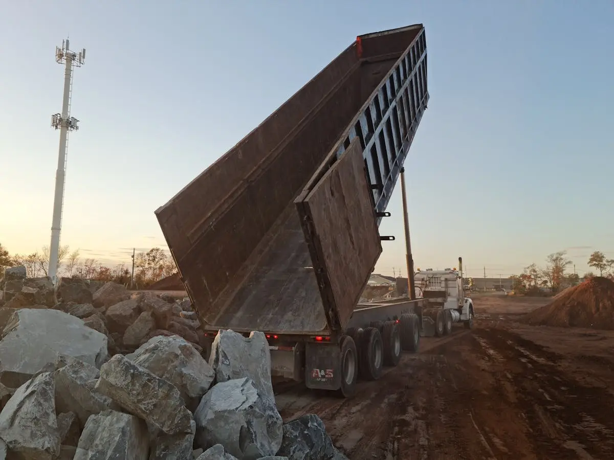 a loaded junk removal truck tipping a load at the transfer station