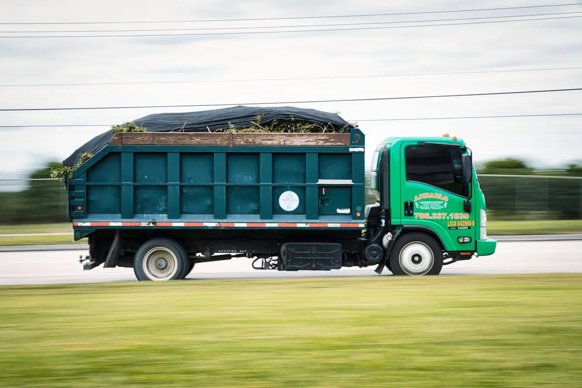 a landscaping truck loaded with cut brush